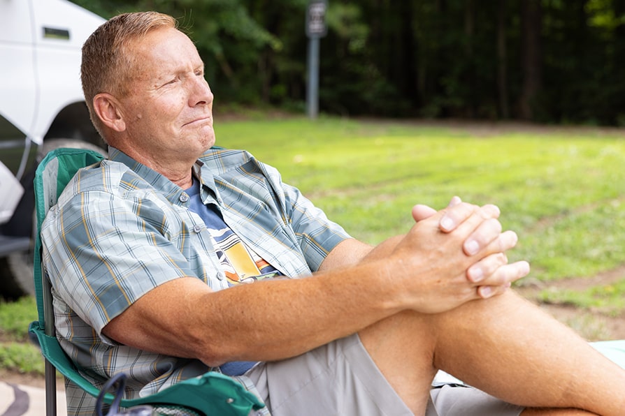 David TECARTUS® (brexucabtagene autoleucel) patient ambassador sitting in a chair.